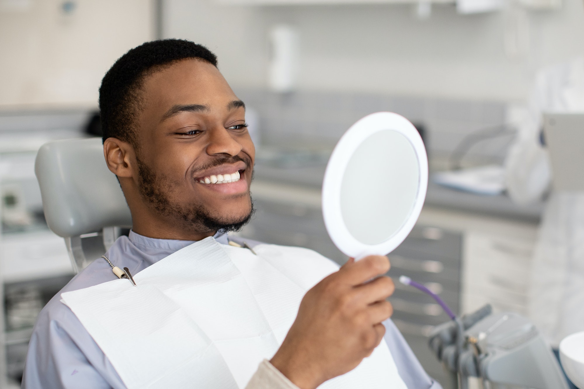 patient looking at mirror after treatment