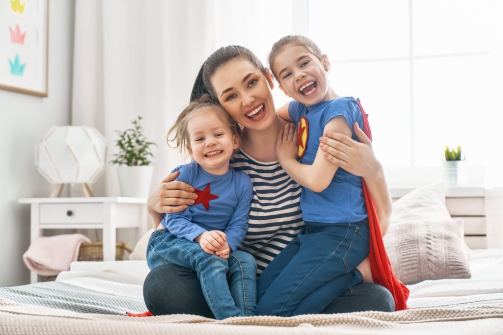 mother and her daughters sitting on a couch