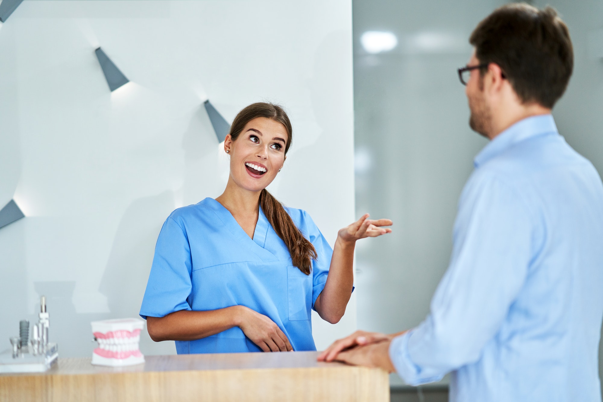 Patient paying for dental visit in clinic